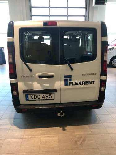 White flexrent van from behind.